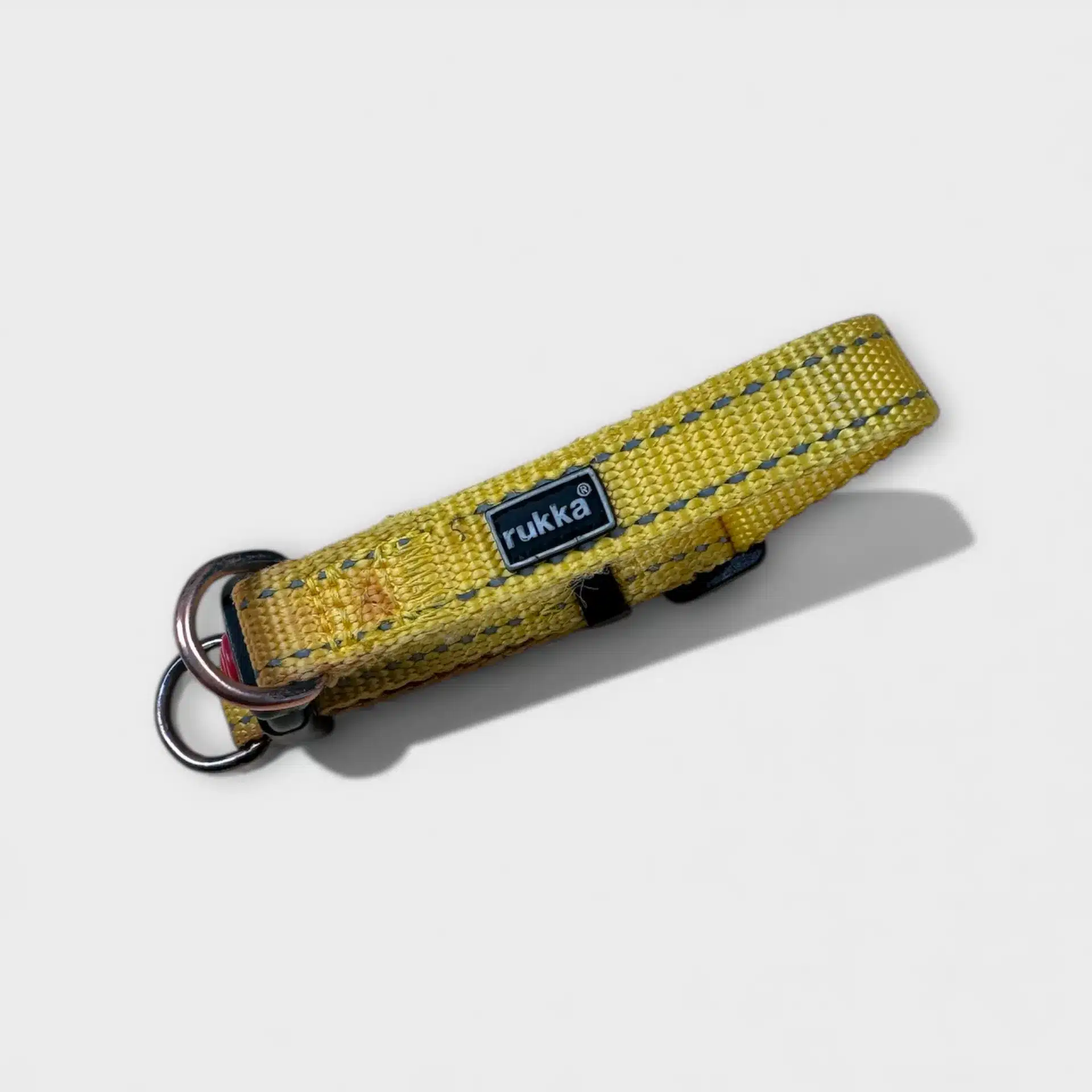 Yellow Rukka dog collar with reflective details, adjustable