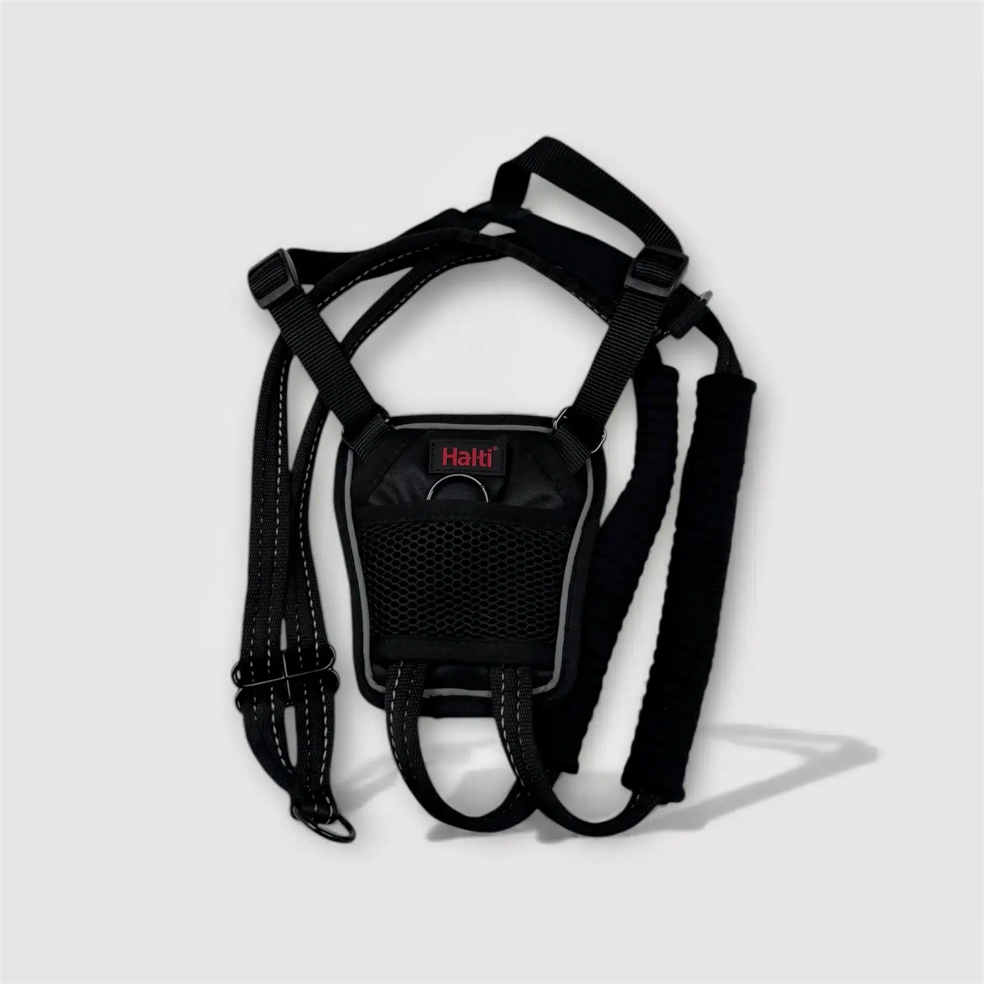 Black Halti No Pull dog harness, adjustable with reflective details.